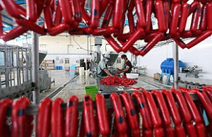epa04167247 Afghan men fill meat into sausages at a sausage factory in Herat, Afghanistan, 14 April 2014. According to local information the factory produces around 4 tonnes of sausages daily, which are mostly consumed in Herat city. The factory's owners were planning to enhance the production to be able to sent their products also to other provinces of the war-torn country, they said.  EPA/JALIL REZAYEE